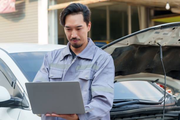 istock Mechanic analyzing car details using laptop while focusing on data, showcasing the use of technology in modern auto repair and diagnostics for precision and quality assurance. 2195204409