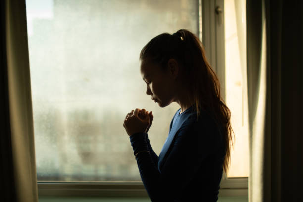 istock Young woman praying to god. 2195204833