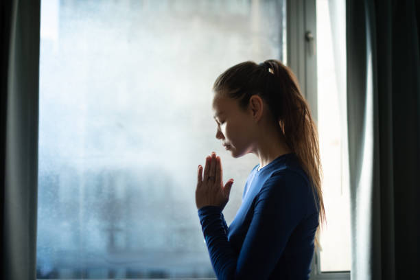 istock Young woman praying to god. 2195204834