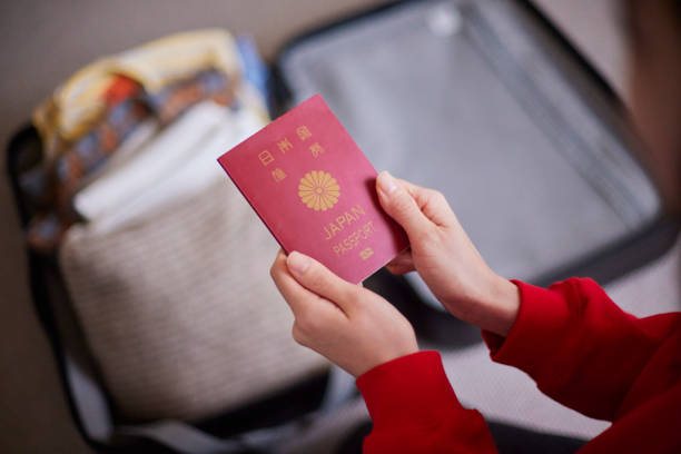 istock A Japanese woman holding a suitcase and passport while preparing 2195205795