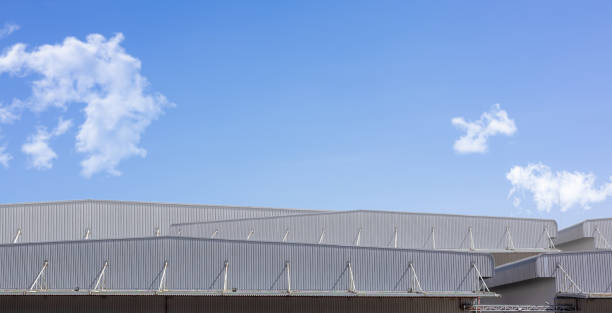 istock Factory industry, Warehouse Construction in Geometric Modern Design, Backdrop Wall Metal Corrugated Steel Surface Pattern, Architecture Building with Aluminium Facade on Blue Sky Background. 2195205880