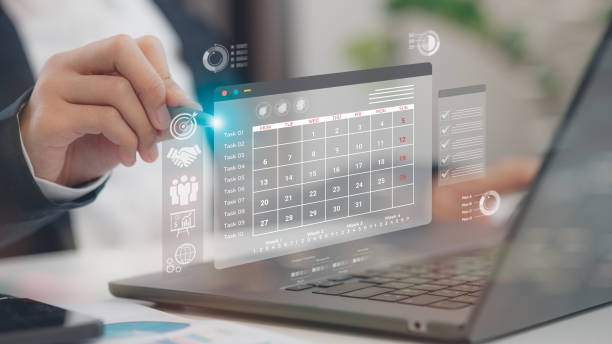 istock Businessman manages time for effective work. Calendar on the virtual screen interface. Highlight appointment reminders and meeting agenda on the calendar. Time management concept. 2195207746