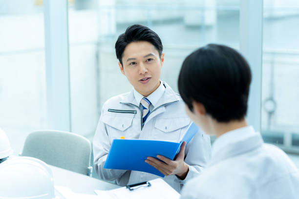 istock Businessmen in work clothes having a meeting 2195208207