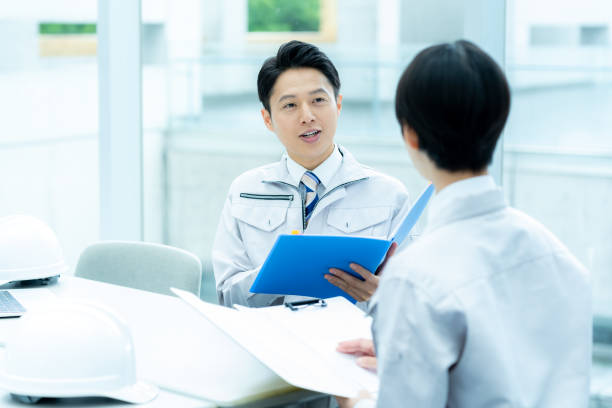 istock Businessmen in work clothes having a meeting 2195208210