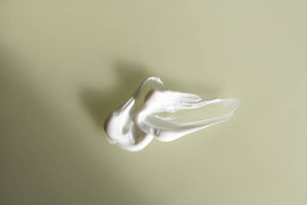 istock White cosmetic cream smear beige background 2195208228