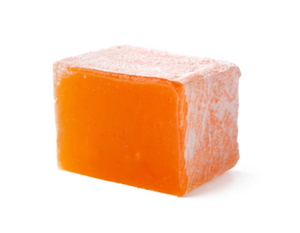 istock Colorful orange gummy candy resting on a clean surface, showcasing its glossy texture and vibrant hue 2195209321