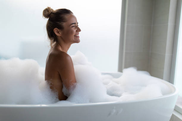 istock Young happy woman enjoying in bubble bath. 2195209786