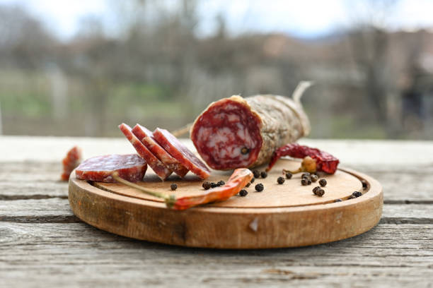 Air-dried typical  Italian salami from Tuscany served on a wooden board .  Autentic Tuscan Salami from San Gimignano, Siena
