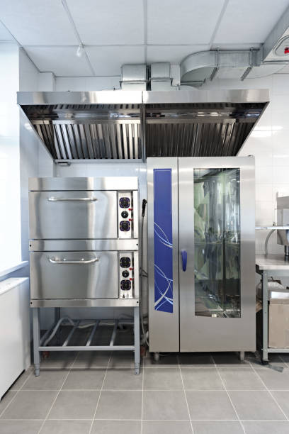 istock Stainless steel kitchen equipment setup with double oven and combi oven in modern food prep area 2195212321