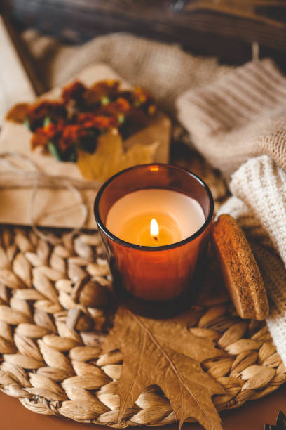 istock Burning candle in a cozy warm homey autumn atmosphere 2195212375