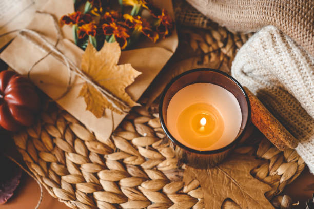 istock Burning candle in a cozy warm homey autumn atmosphere 2195212376
