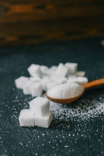 istock White crystalline sugar cubes on a wooden spoon 2195213042