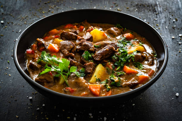 istock Beef stew with vegetables and potatoes on black table 2195213249