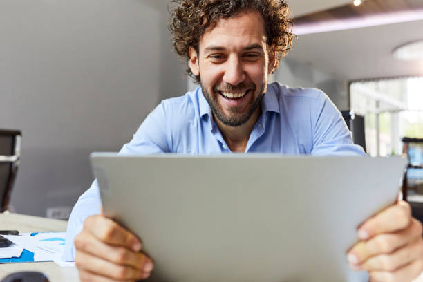 istock Happy businessman working on a computer in the office. 2195214559