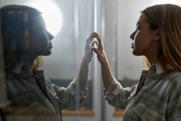 istock Young creative woman examining plans on a glass wall. 2195215795