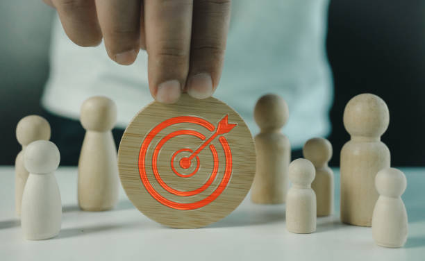 istock Man put target icon for set up challenge and opportunity. Goal setting and target concept. Target dartboard icons on wooden circles. 2195216393