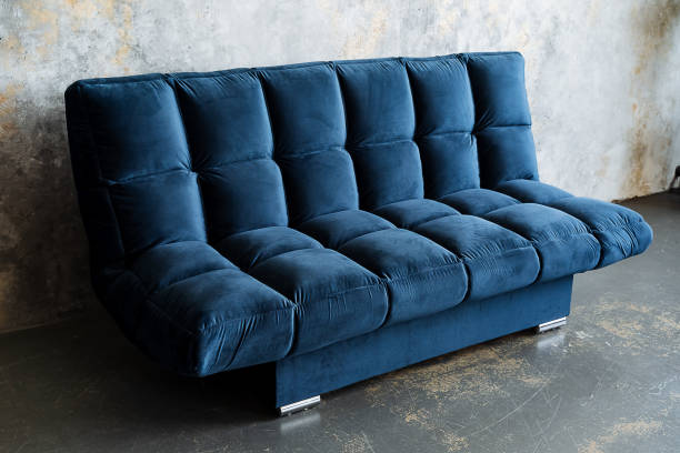 istock A vibrant blue couch is displayed prominently in a room adjacent to a wall 2195217847