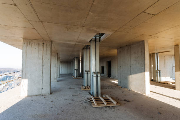 istock A large, vacant building that is currently in the process of construction, showcasing numerous sturdy concrete pillars. This expansive space holds immense potential for a variety of uses 2195217913