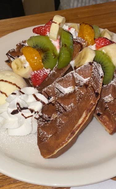 Crispy, golden waffles topped with creamy ice cream, creating a perfect balance of warm and cold, crunchy and smooth. A delightful dessert or breakfast treat, made even better with toppings like fruits or syrup.