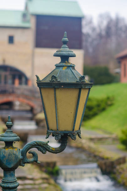 vintage lantern with ornate details, casting warm glow against blurred backdrop. High quality photo