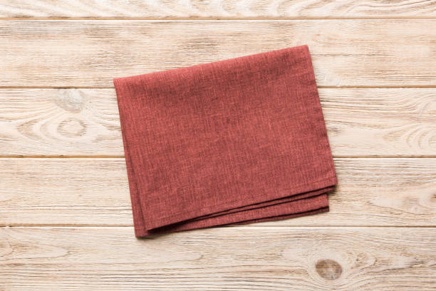 istock top view with red empty kitchen napkin isolated on table background. Folded cloth for mockup with copy space, Flat lay. Minimal style 2195222898