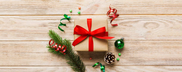 istock Top view Flat lay Christmas decorations and gift box on colored background with copy space. Christmas or Happy New Year composition 2195222939