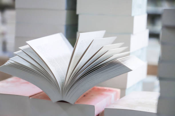 istock stack of books, close up. Open book on the table in library. Back to school concept. 2195222996
