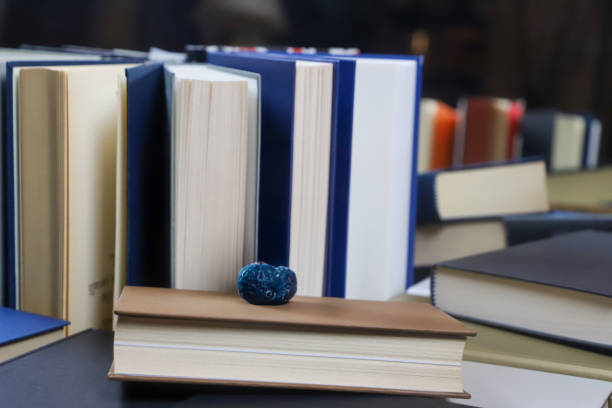 stack of books, close up. Open book on the table in library. Back to school concept.