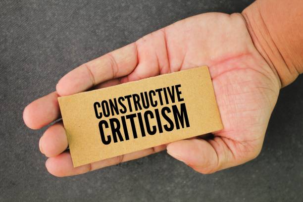 istock hand and paper with the word constructive criticism. type of feedback that offers specific and actionable advice to help employees to improve 2195223280