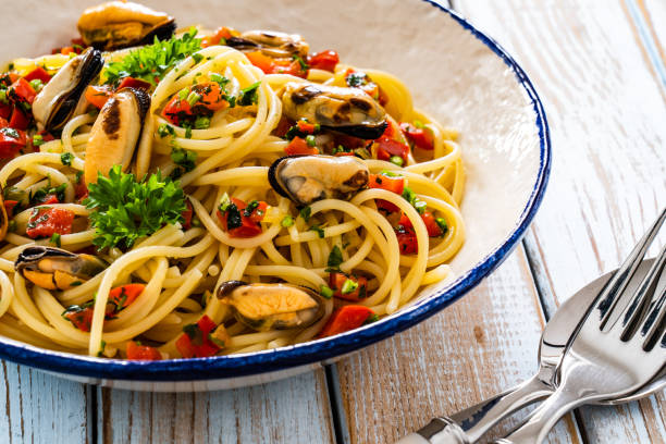 istock Noodles with mussels on wooden table 2195224078