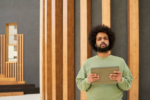istock Portrait of Man Holding Tablet With Bamboo Background 2195224322