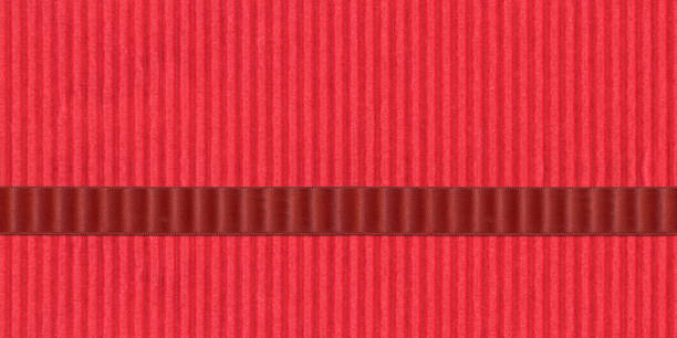 Red ribbon on red paper background.