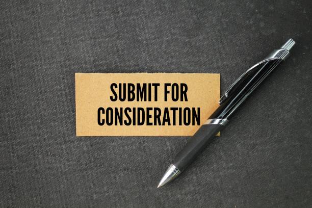 istock pen and paper with the word submit for consideration. a request or proposal that has been brought forward and is awaiting review. 2195228112