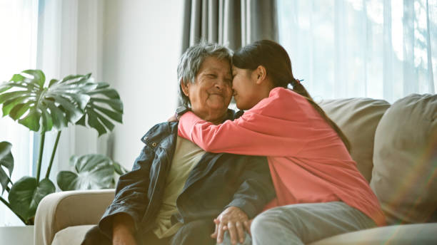 istock Elderly and teen relax talking at home. 2195229794
