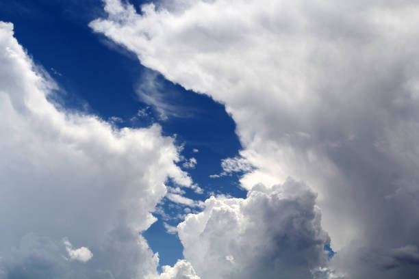 Cumulus storm clouds forming in a blue sky