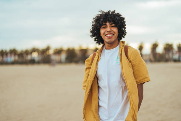 Smiling Man Enjoying a Relaxed Day at a Scenic Beach