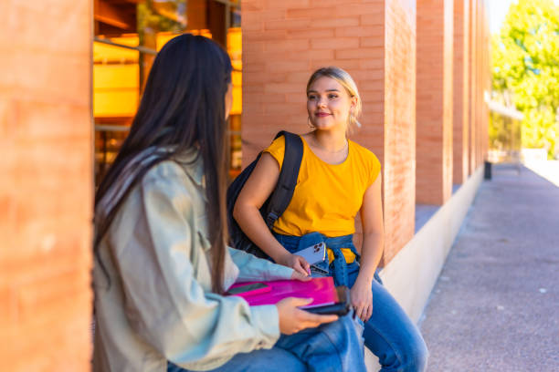 istock Multi-ethnic friends sitting and talking at the university campus 2195230838