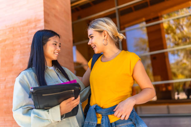istock Happy multi-ethnic students talking outside the university building 2195230863