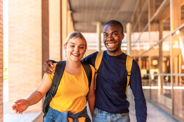 istock Multi-ethnic friends embracing from shoulder walking along the university 2195230941