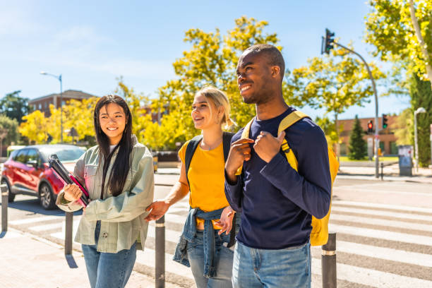 istock Happy multi-ethnic students walking along the city 2195230982