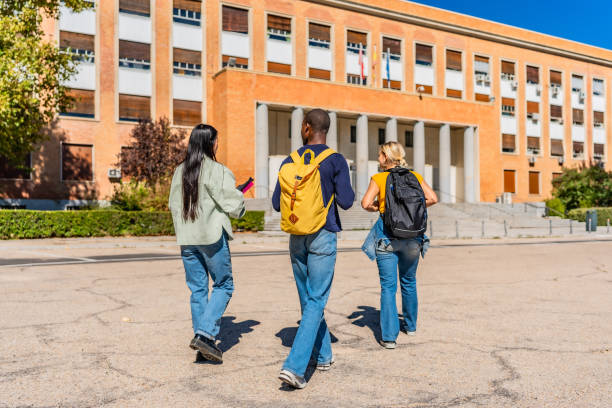 istock Three students walking along the campus in a sunny day 2195231018