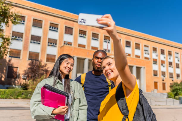 istock Multi-ethnic university students taking selfie in the campus 2195231023