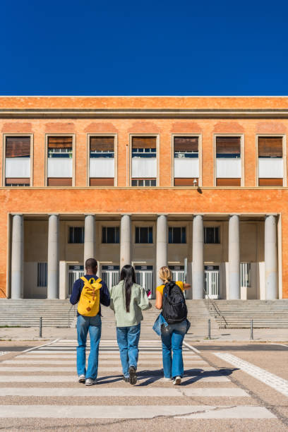 istock Students walking on pedestrian crossing to the university campus 2195231117