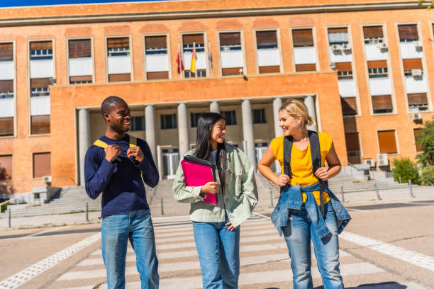 Group of three young female friends in the city. All about 20 years old, diverse women (Caucasian, Black and Middle-Eastern).