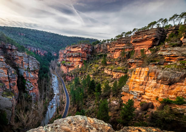 istock Road, conifers and river and Gallo gorge 2195231189