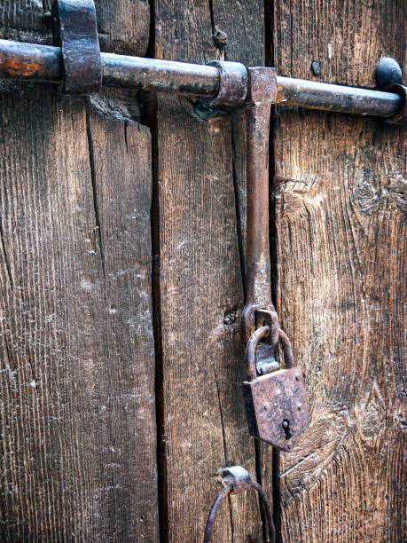 istock Deadbolt with padlock on wooden door 2195231415