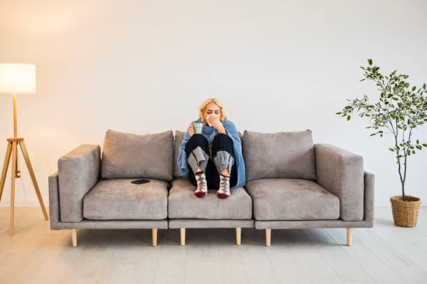 istock Exhausted Woman on Sofa with Cold and Flu 2195232555