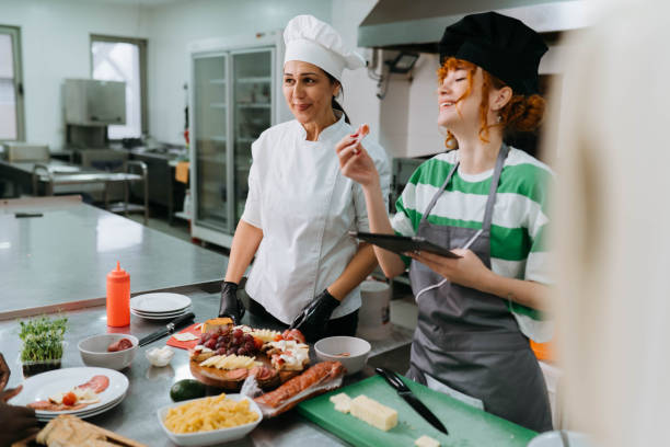 Chef assisting members of a cooking class