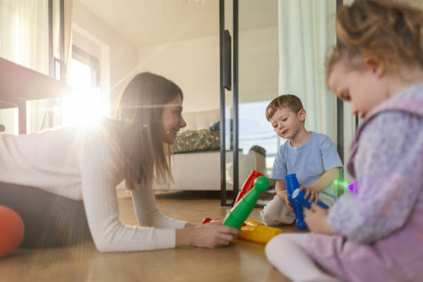 istock Mother and kids playing with bowling pins on the floor 2195233105