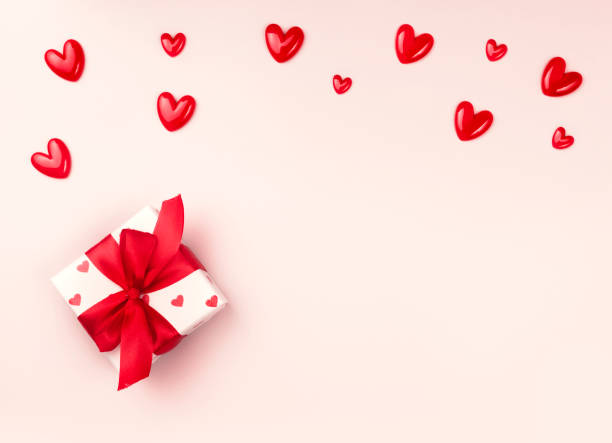 istock Valentine's day background empty copy space, gift box with red bow decorated with hearts flatlay.Holiday card. 2195233161